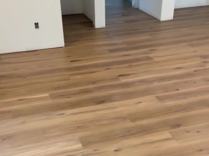Finished luxury vinyl plank floor installed by Grand Com, straight lines wall to wall